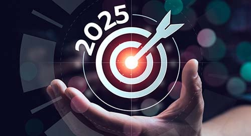 A hand holding a bullseye with 2025.