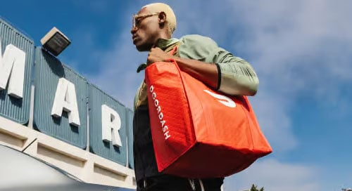 Man carrying DoorDash bag